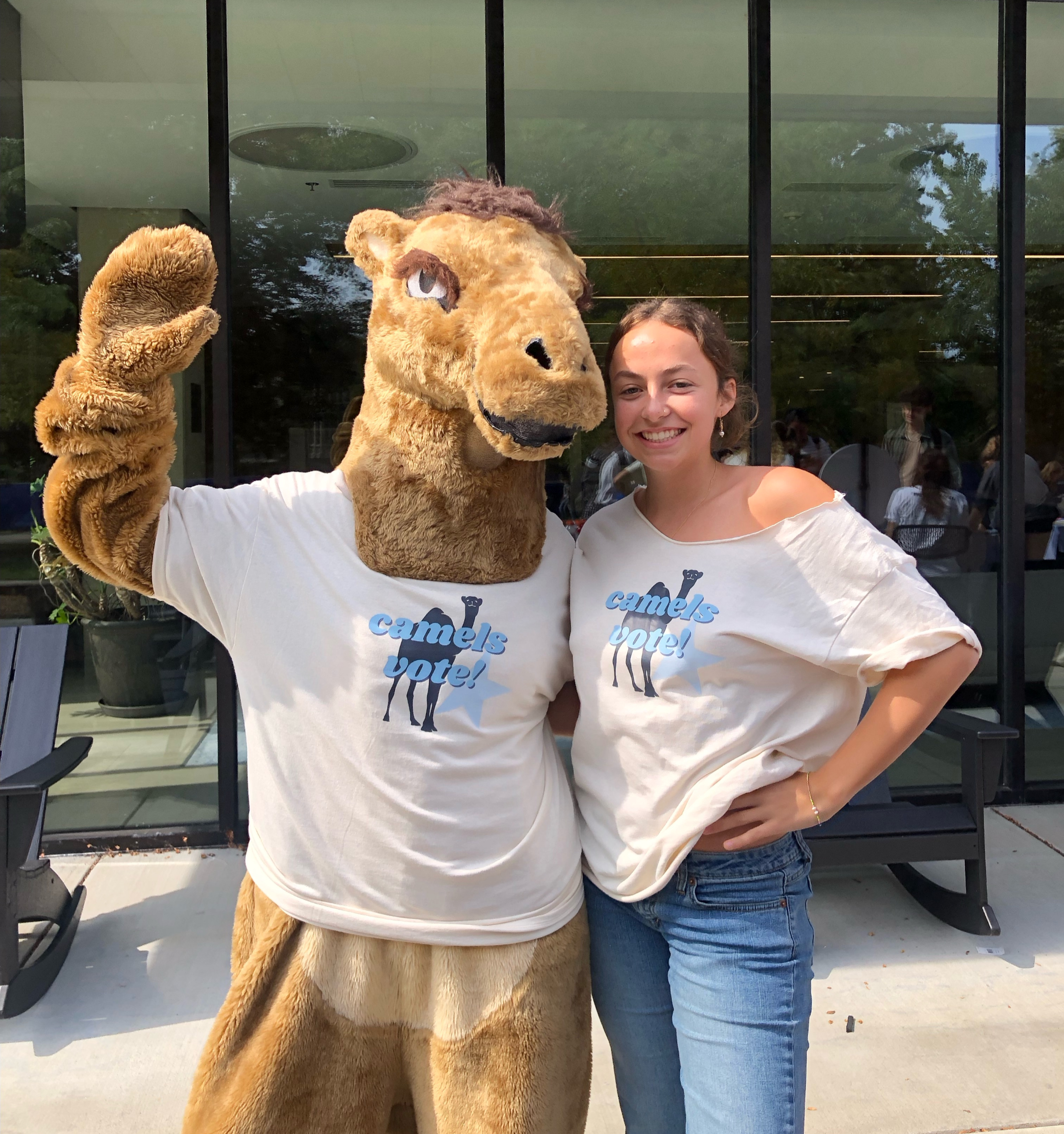 A Camels Vote student ambassador posing with the Connecticut College camel mascot, both in “camels vote!” t-shirts.