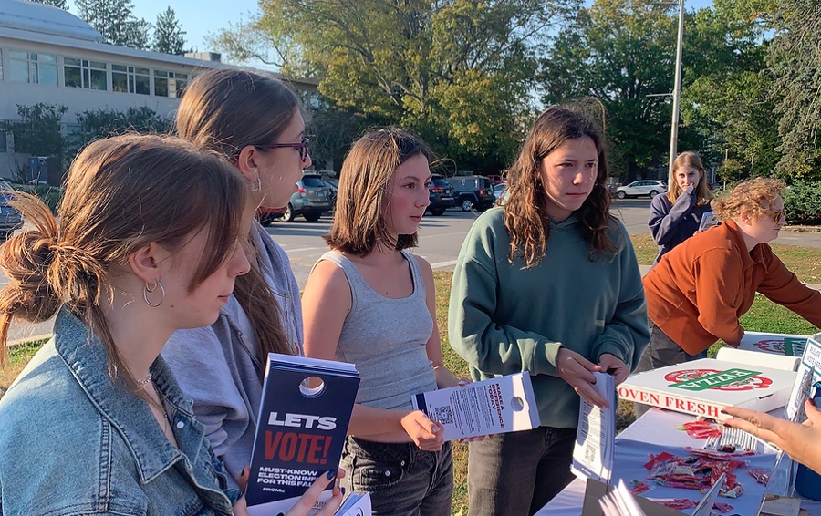 Camels Vote volunteers with voting-information door hangers during Storm the Dorms.